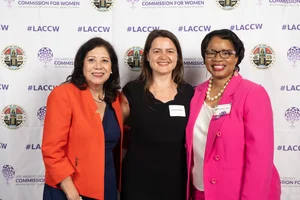 Supervisor Holis smiling for a photo with 2 other women.