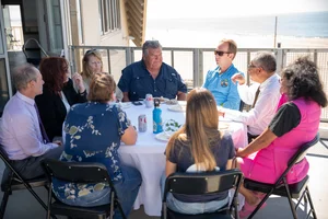 a group of people sitting at a table outside
