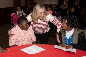 Supervisor Barger speaking with two young children at a table