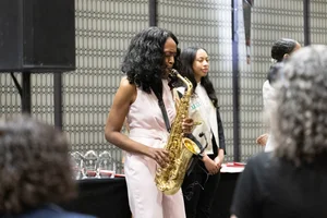 a woman playing a trumpet on stage.