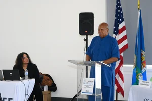 a man speaking at the podium at the event.
