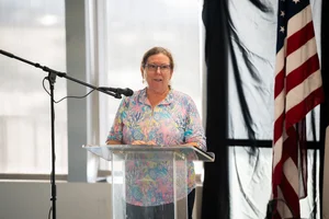 a woman speaking at a podium