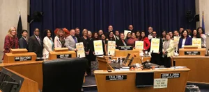 group photo of people holding up different awards.