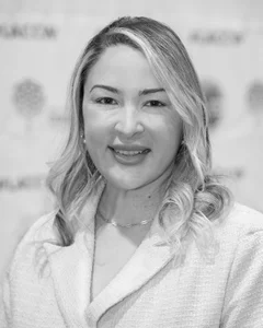 Woman smiling for a photo in black and white.