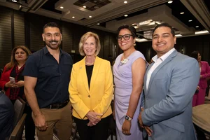 Supervisor Hahn smiling for a group photo with 3 other people.