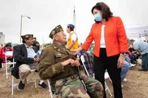 Supervisor Solis speaking to a veteran the Memorial Day East LA
