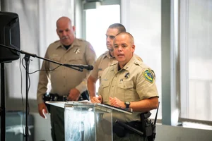 officers speaking at a podium
