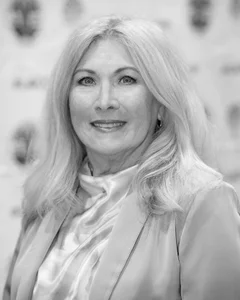 Woman smiling for a photo in black and white.