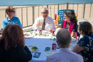 a group of people sitting at a table outside