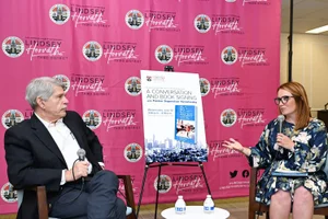 Supervisor Horvath speaking to someone at a book signing event