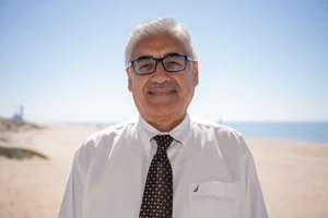 a man standing in front of the beach