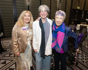 3 woman smiling for a photo.