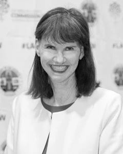 Woman smiling for a photo in black and white.