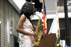 a woman playing the saxophone on stage.