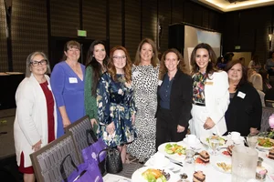 a group photo of people smiling.