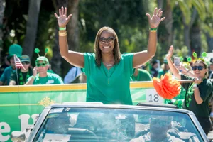 Supervisor Mitchell waving from a car at the Hermosa Beach Annual St. Patrick Parade