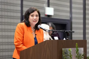 Supervisor Holis speaking at a podium.