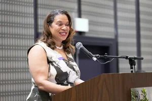 A woman speaking at the podium.