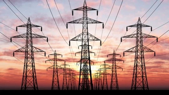 Powerlines with a sunset in the background.