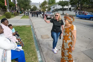 Supervisor Barger waving at a parade while walking down the street