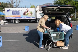 Supervisor Barger giving donations out from back trunk of a SUV