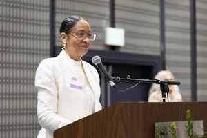 a woman smiling at the podium
