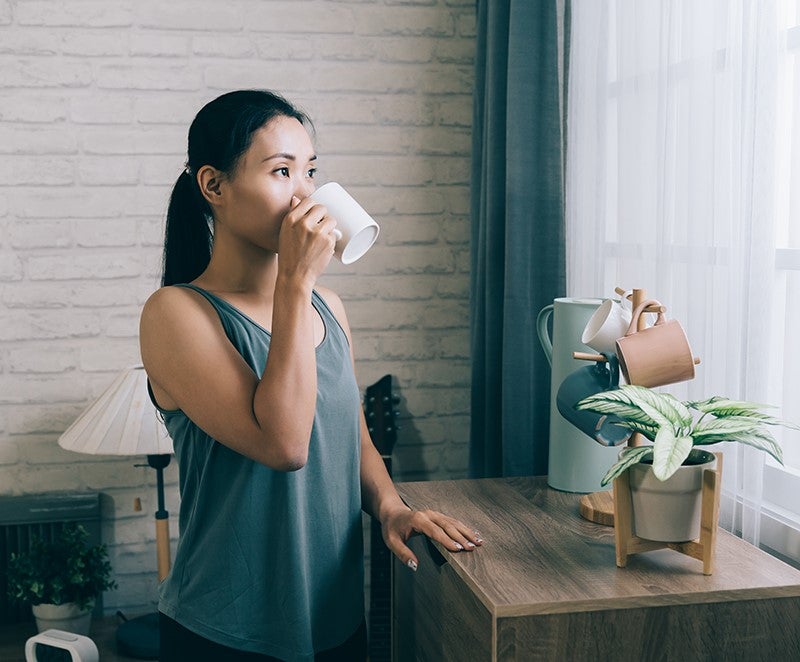 Woman drinking coffee at home