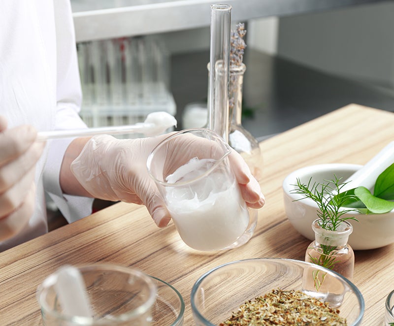 Woman testing ingredients for a skincare formula