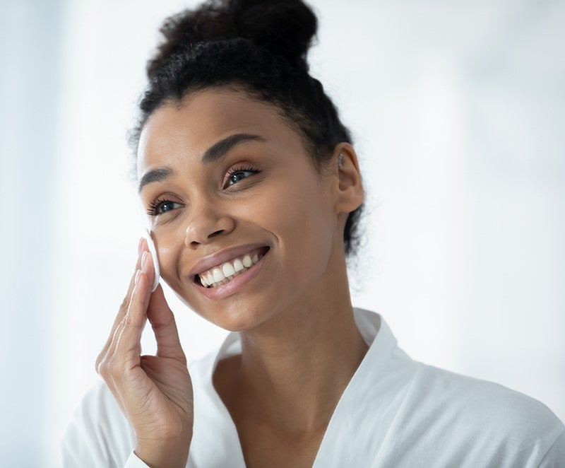 Woman practicing a skin care routine.