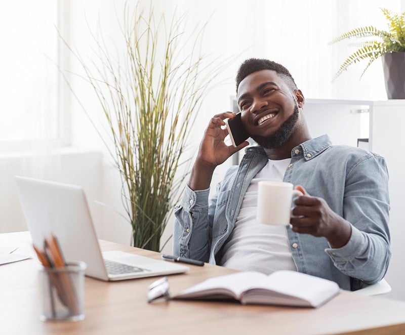 Man on laptop drinking coffee