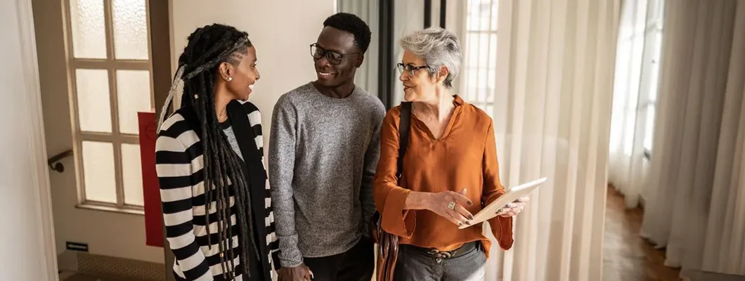 Landlord showing apartment to young couple. Find Massachusetts Landlord Insurance.