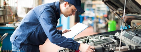 Portrait of a mechanic at work in his garage. Cars that are the cheapest to maintain. 