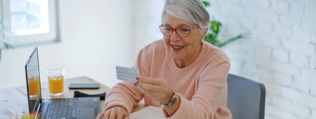 Woman online using laptop with insurance card. Car Insurance Policy Number. 