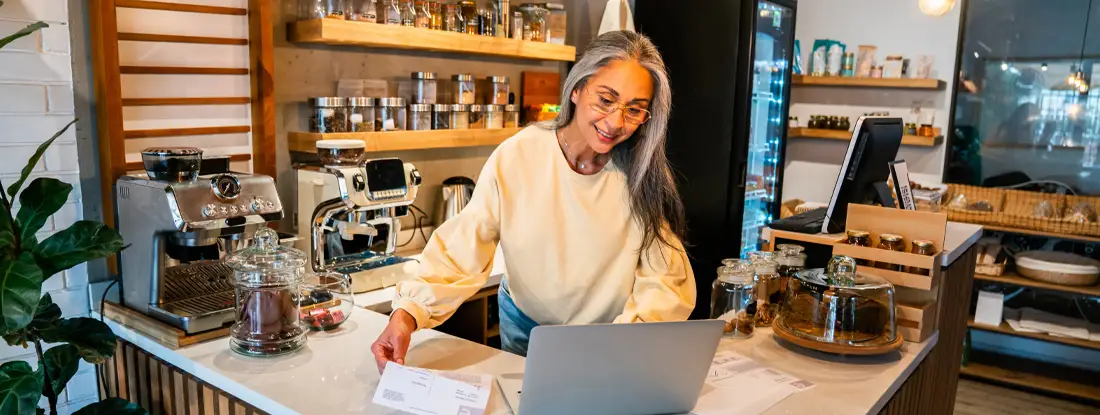 Small business owner doing the accountancy at a coffee shop. What Does General Liability Insurance Cover?