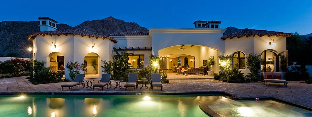 Backyard with illuminated swimming pool at dusk. How to Find the Best Homeowners Insurance in Glendale, Arizona. 