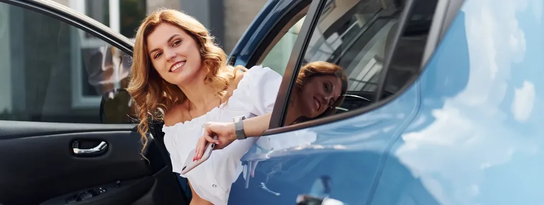 Young woman getting out of car. How to Find the Best Car Insurance in Chevy Chase, Maryland.