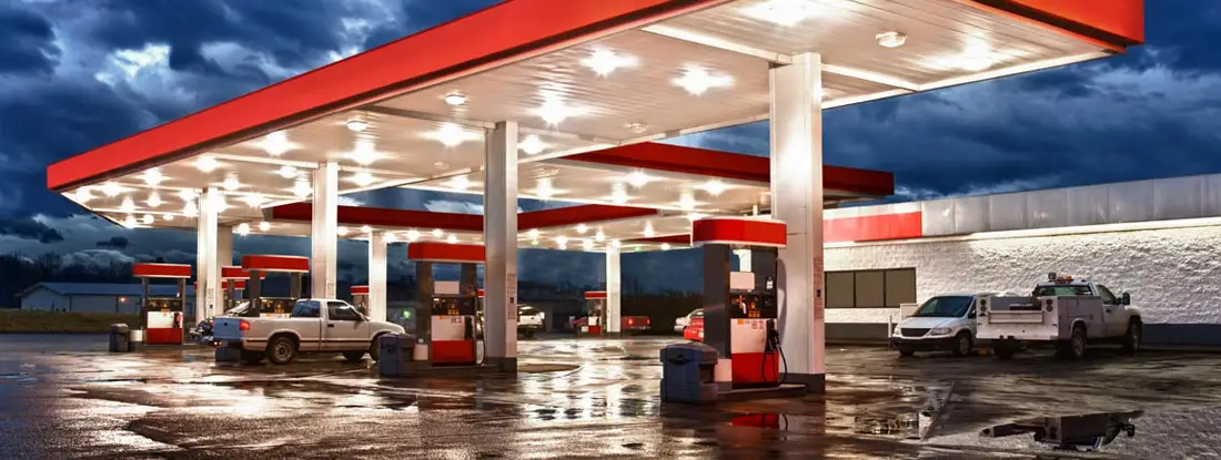 Gasoline station and convenience store after an evening rain. Find gas station insurance.