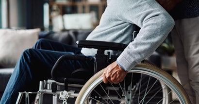 Low angle shot of man moving in his wheelchair  at home during the day. Find Individual disability insurance.