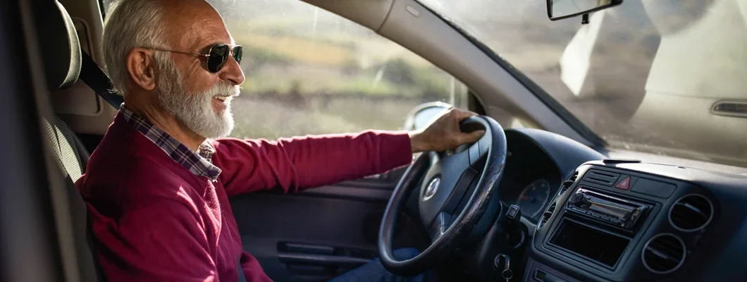 Happy senior man going on a trip by car. How to Find the Best Car Insurance in Lewiston, Maine.