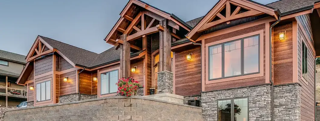 Twilight shot of large home with natural wood look. St. Peters, MO Homeowners Insurance.