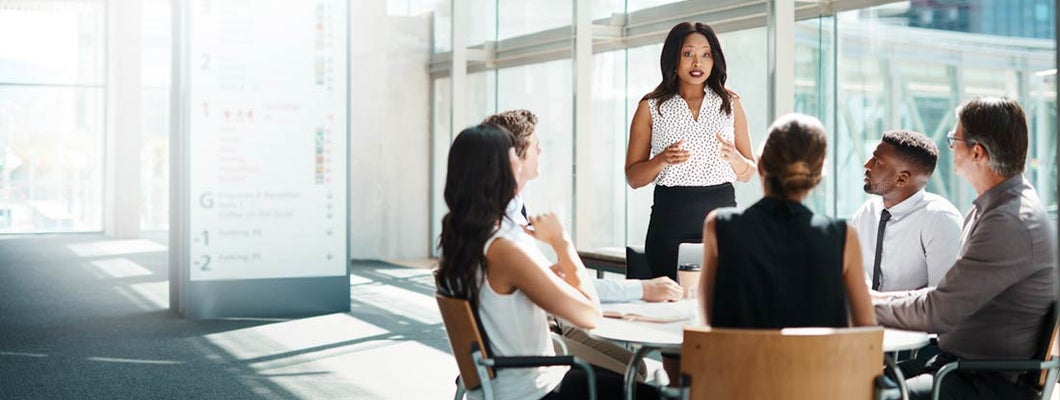 Businesspeople having a meeting in a modern office. Long term group disability cost.