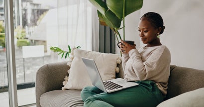 Woman having coffee and shopping online for insurance. Which is better, an independent agent or an online bot?