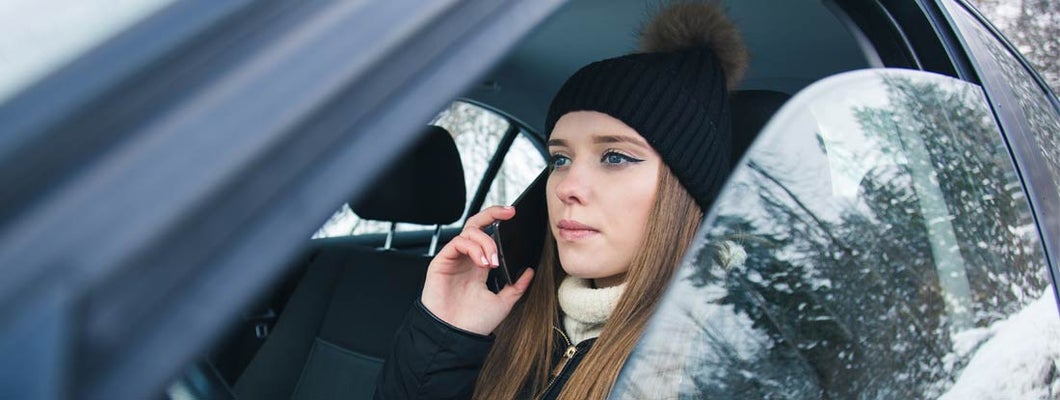 Distracted Driver Talking on Phone in Minnesota winter. Distracted Driving Laws by State.