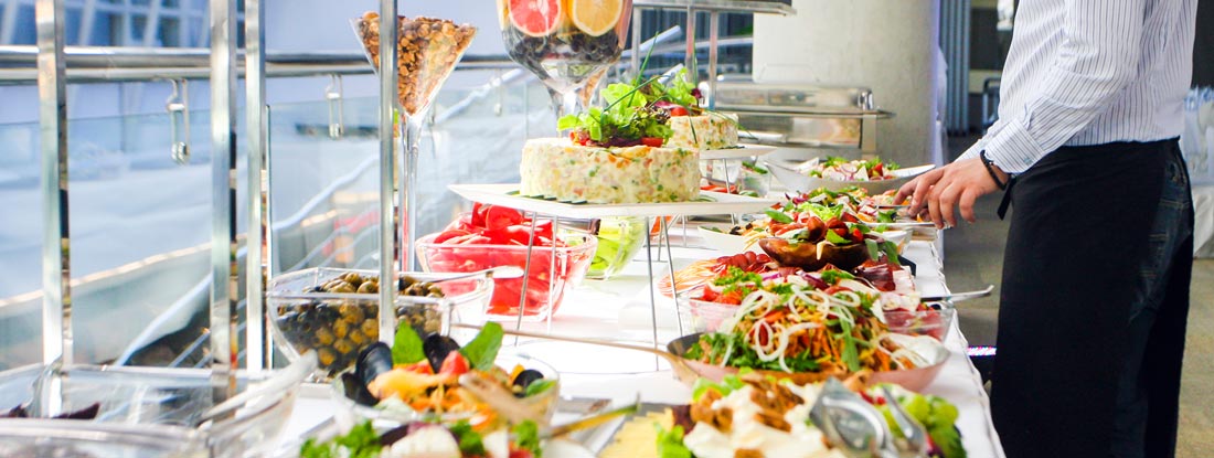 Woman setting up Buffet. Mississippi Catering Insurance.