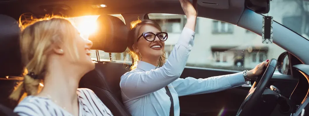 Friends enjoying road trip traveling at vacation in the car. Find Elko, Nevada car insurance.