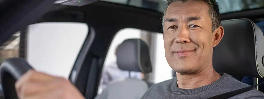 Smiling man driving his car. Find Middleton, Delaware car insurance.