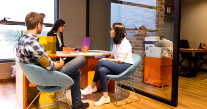 Couple getting advice in office from agent. Why work with an independent agent in Missouri.