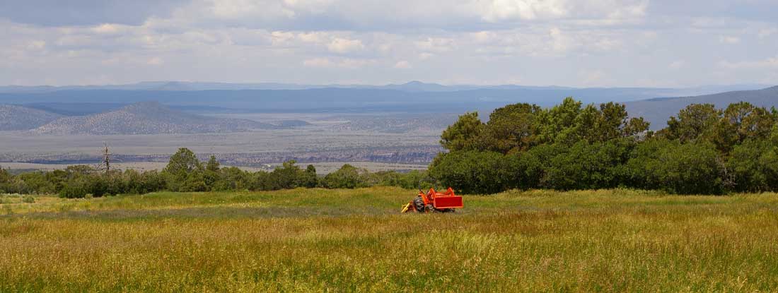 Red tractor on farmland. New Mexico State Laws and Regs.