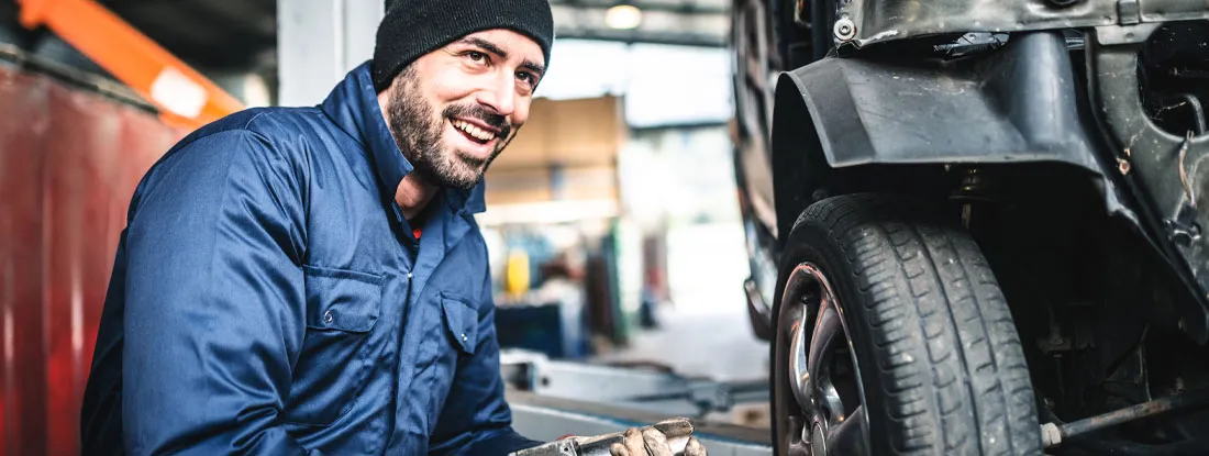 Changing the tire. Find Bailee Coverage Insurance.