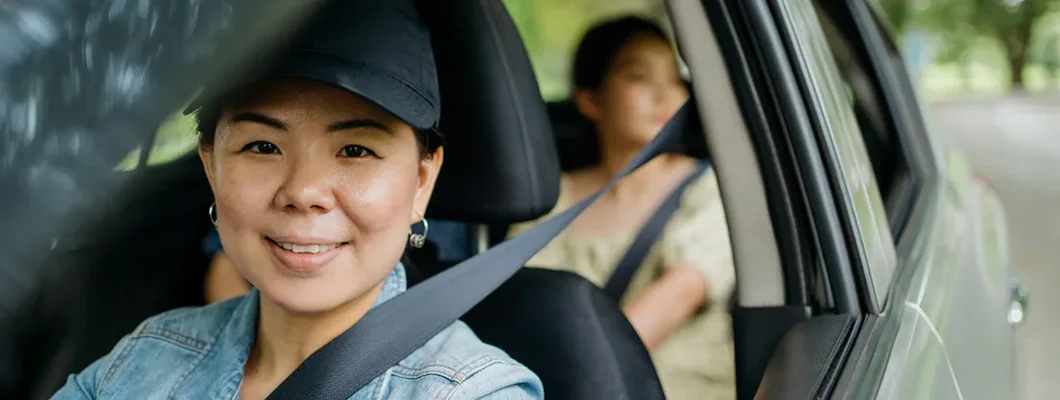 Smiling mother sitting in car and looking at camera. How to Find the Best Car Insurance Coverage in Shaker Heights, Ohio.